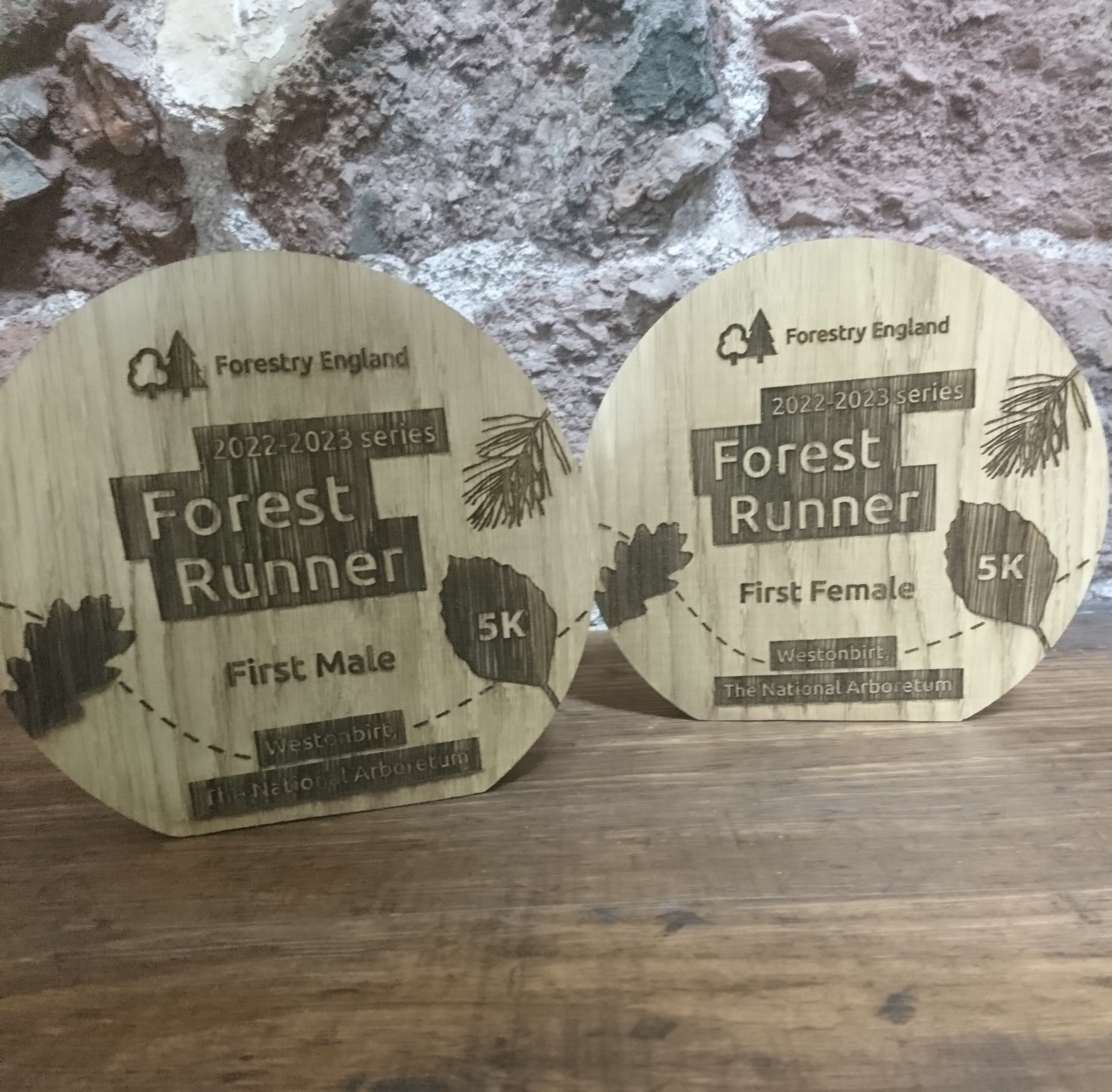 Forestry England Forest Runner trophies in a round shape with flat bottom and engraved with logo and leaf design